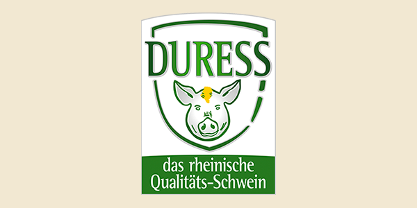Das Logo zeigt ein Wappen mit einem illustrierten Schweinekopf und den Text „Duress, das rheinische Qualitäts-Schwein“.  